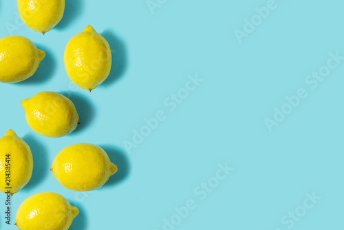 Top view of fresh lemon isolated on blue background. Fruit minimal concept. Flat lay.