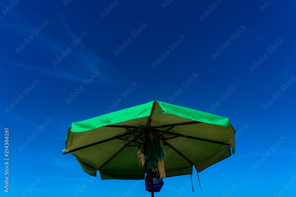 Green umbrella under the blue sky