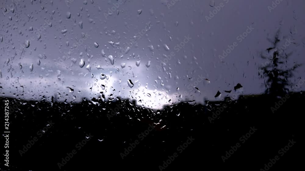 raindrops running down from window glass during the rainy weather raindrops running down from window glass during the rainy weather
