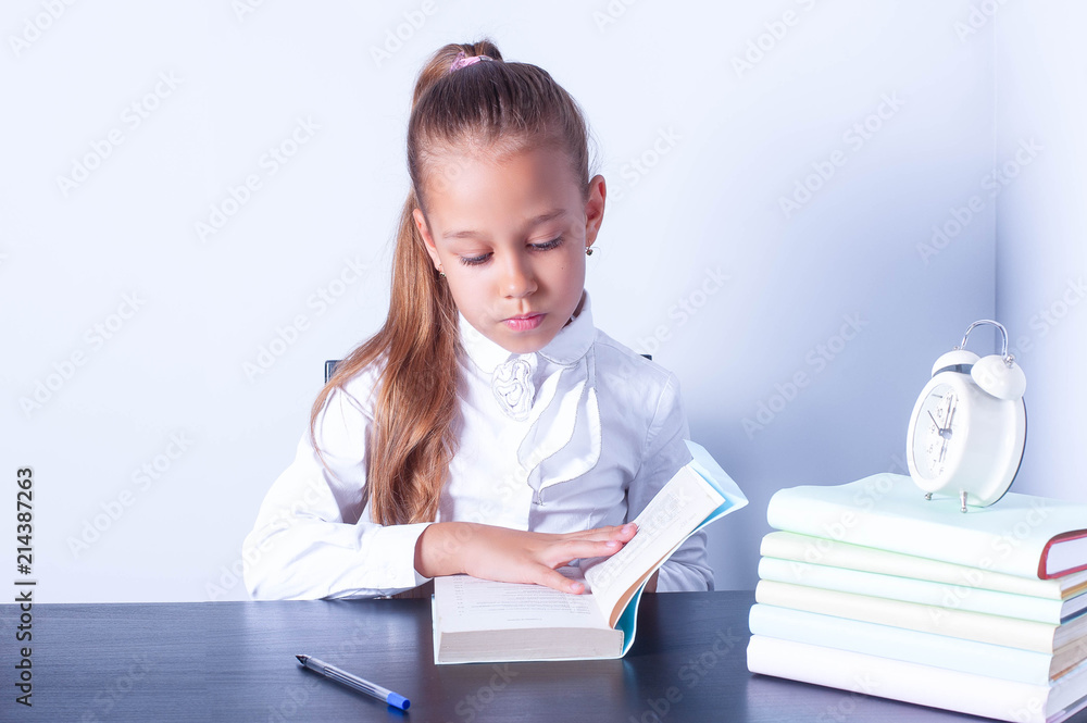 cute baby doing homework, reading a book, students learn to write and read. Back to school. academic year. cute baby doing homework, reading a book, students learn to write and read. Back to school. academic year.