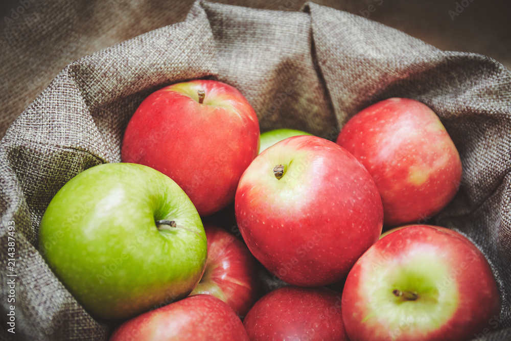 Selective forcus, close-up of red apples in basket, Sackcloth texture background Selective forcus, close-up of red apples in basket, Sackcloth texture background