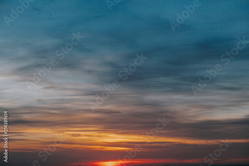 Sunset. Amazing beautiful sunset or sunrise on sky with clouds in yellow, pink and blue colors. Dawn or dusk. Nature wallpaper.