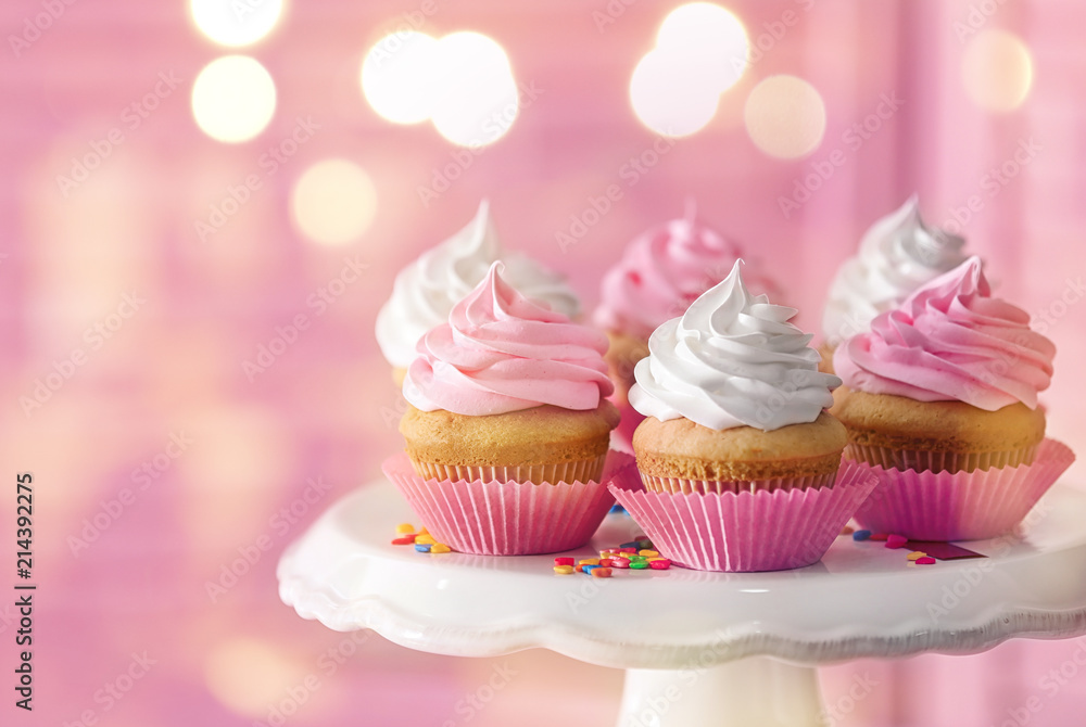 Dessert stand with delicious cupcakes on blurred background Dessert stand with delicious cupcakes on blurred background