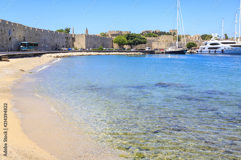 Akti sachtouri sand beach in old town Rhodes with city walls in Rhodes, Dodecanese, Greece