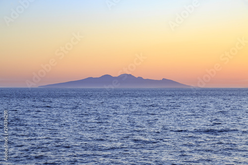 Entire Symi island view from distance during sunset in aegean sea near Symi, Dodecanese, Greece