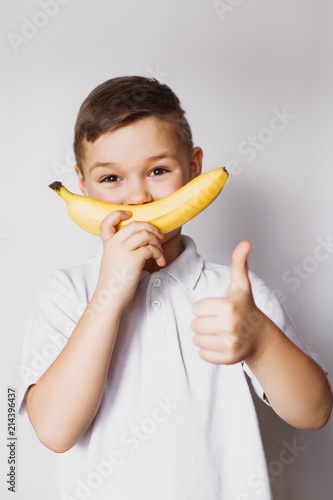 boy holding a banana in hand
