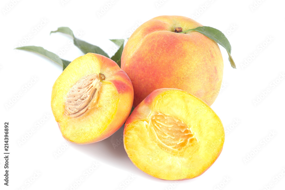 Large fresh peach with green leaf and peach halves on white isolated background. Large fresh peach with green leaf and peach halves on white isolated background.