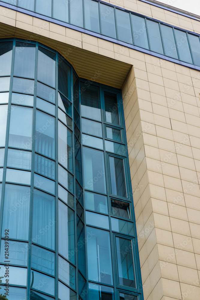 Obraz premium building facade with blue glass windows with tiles, vertical frame