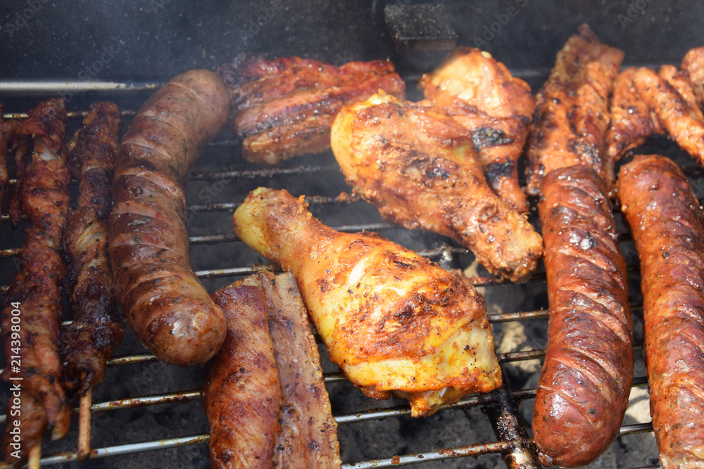 sausages, shish kebabs chicken and bacon baked on the grill