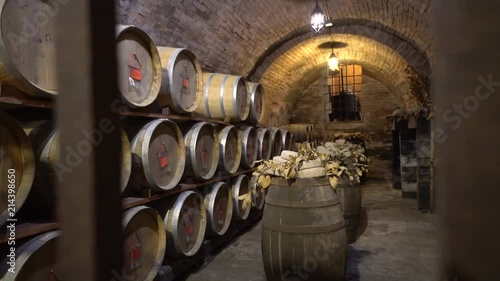 Montepulciano, Italy - November 1, 2016: Oak barrels in an old Italian wine cellar.