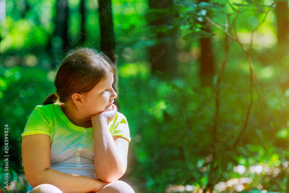 Portrait beautiful little kid cute girl looking to one side in garden park Portrait beautiful little kid cute girl looking to one side in garden park