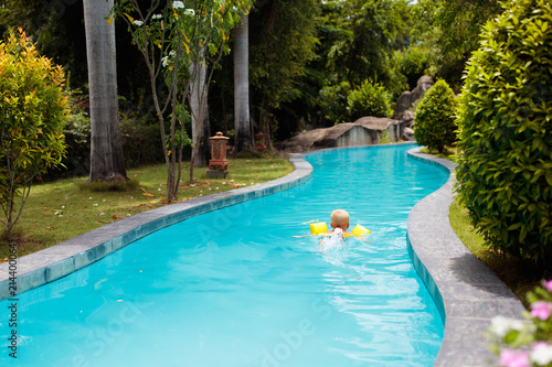 Baby in swimming pool. Kids swim aid. © famveldman