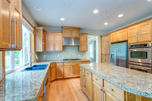 Amazing kitchen room with honey colored cabinets.