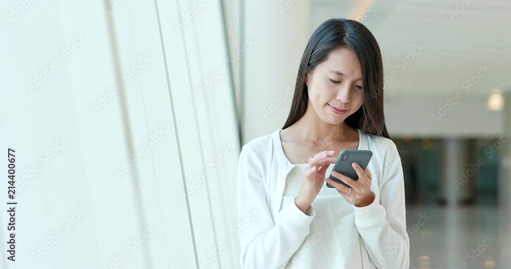 Woman use of mobile phone in shopping mall Woman use of mobile phone in shopping mall