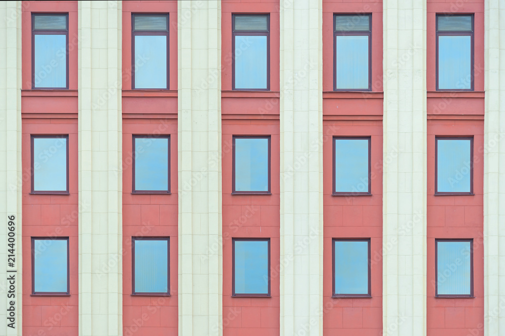 Colourful red fasade wall with columns and windows texture