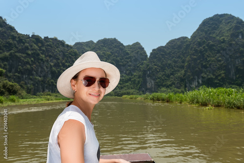 Woman in hat traveling by boat on river among the islands © len4foto