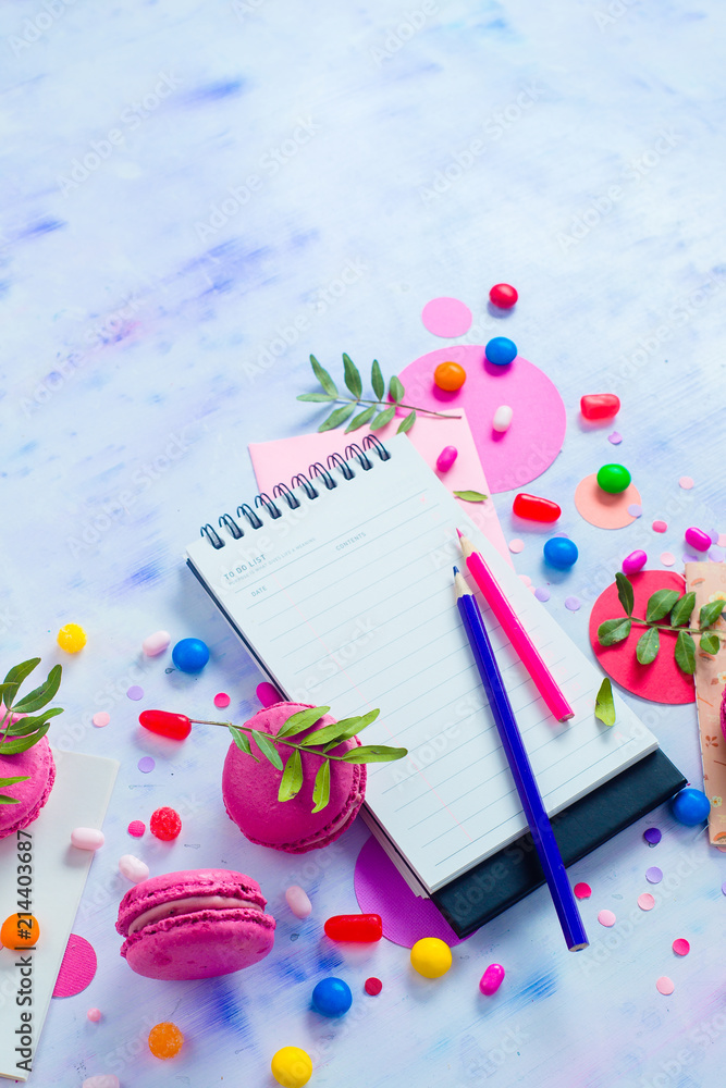 Colorful notebook with pencils and confetti on a light background with copy space. Pink and purple palette still life. Easy lifestyle concept Colorful notebook with pencils and confetti on a light background with copy space. Pink and purple palette still life. Easy lifestyle concept