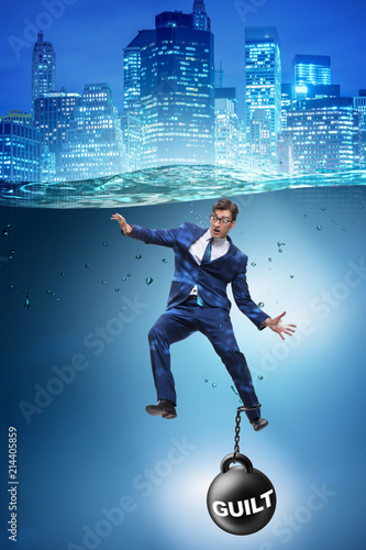 Fototapeta Businessman drowning under the burden of sin and guilt