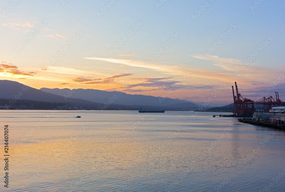 Vancouver Harbor panorama at sunrise. Sunrise over mountains with a view on North Vancouver and city port.