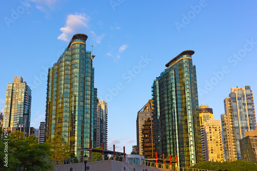 Vancouver city skyscrapers at sunrise in summer. Coal Harbor waterfront modern buildings. © avmedved