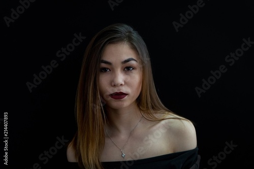 Girl on a black background. Portrait