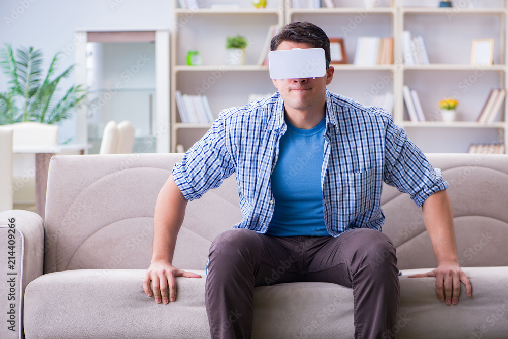 Man with virtual reality glasses playing at home Man with virtual reality glasses playing at home