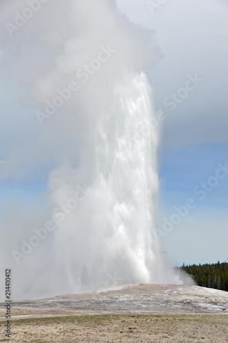 Old Faithful, a geothermal geyser erupting in Yellowstone National Park, Wyoming USA 