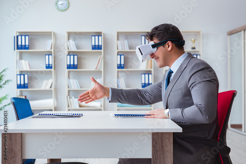 Businessman with virtual reality glasses in the office