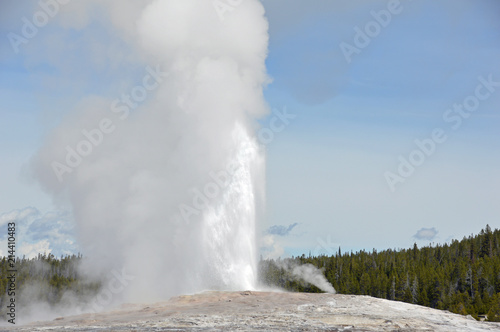 Old Faithful, a geothermal geyser erupting in Yellowstone National Park, Wyoming USA