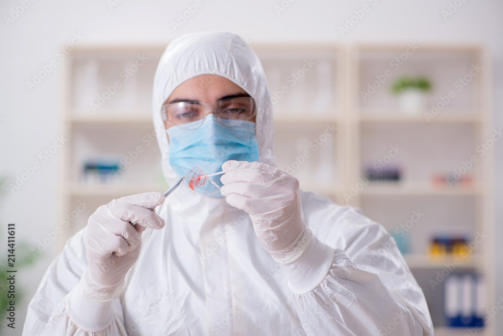 Expert criminologist working in the lab for evidence Expert criminologist working in the lab for evidence