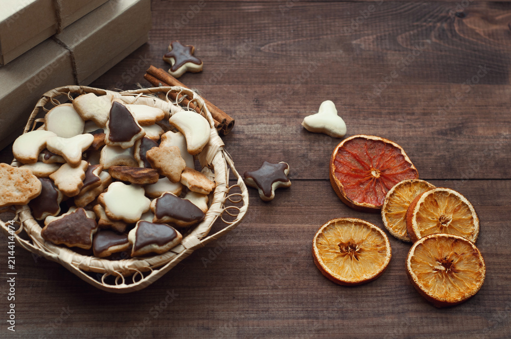 Top view of Christmas background. Christmas cookies and dry oranges on a brown wooden table. Top view of Christmas background. Christmas cookies and dry oranges on a brown wooden table.