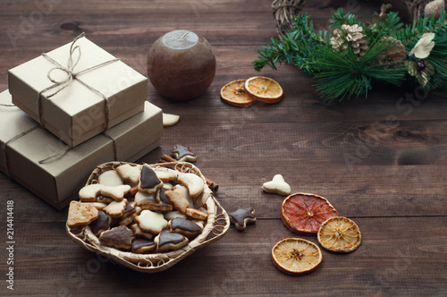 Top view of Christmas background. Christmas presents,cookies and dry oranges on a brown wooden table.