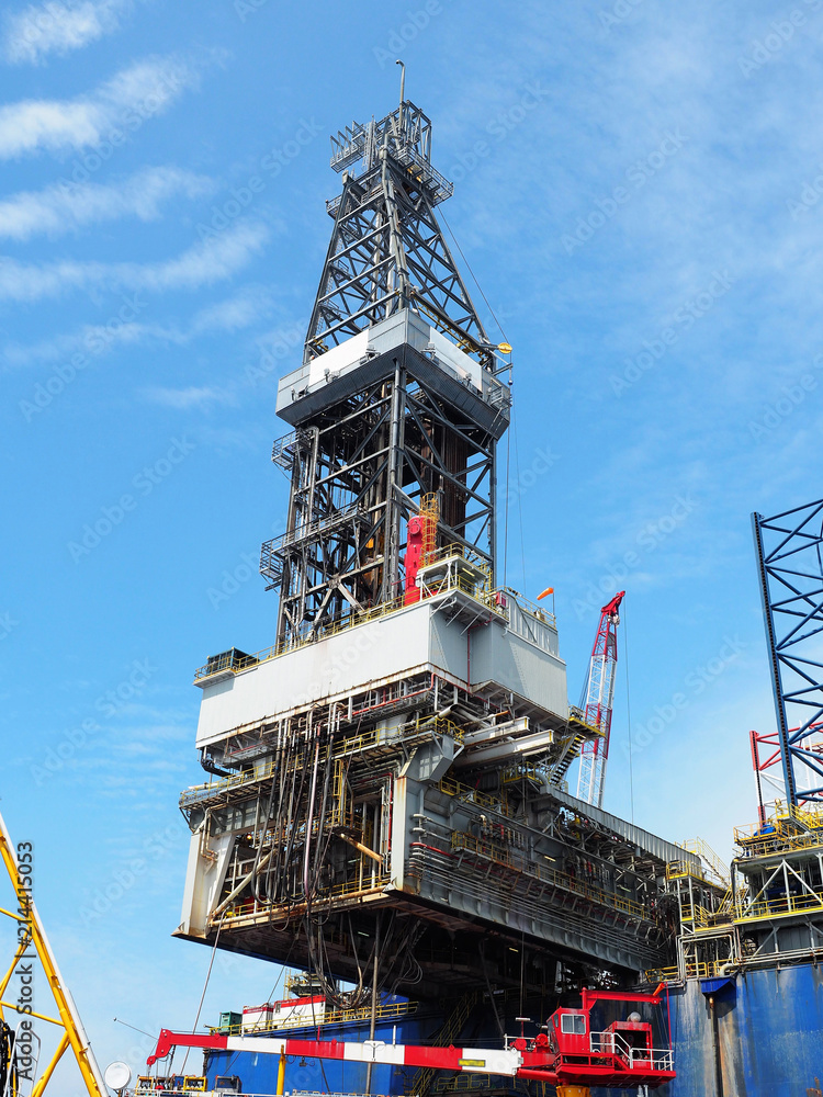 Jack up rig derrick on the cantilever skids out over static platform