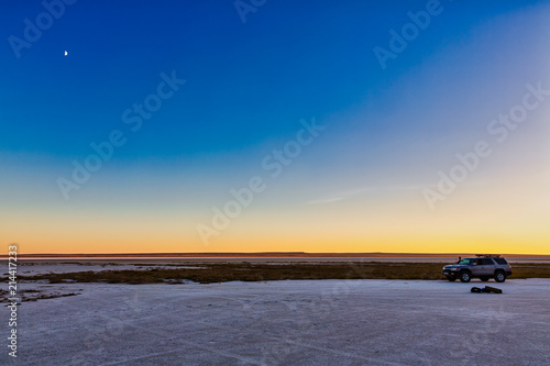 The stunning Blue Hour at sunset above the tent night of the shore of Tuzbair salt dry lake, Mangystau, Kazakhstan photo