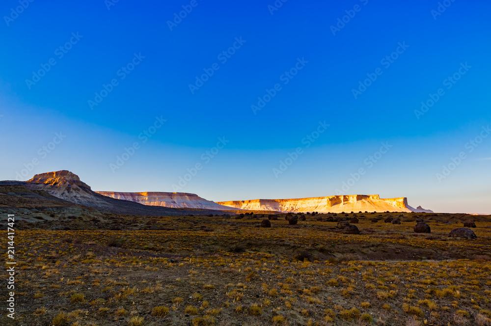 Fototapeta premium The stunning views of the chalk cliffs and round rocks at eary morning in Naizatau, Mangystau, Kazakhstan