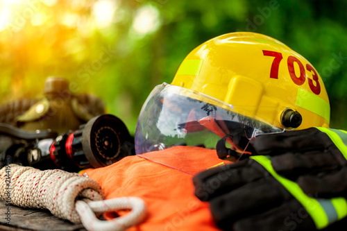 Outfit of Firefighter placed on nature background, Fire equipment concept.