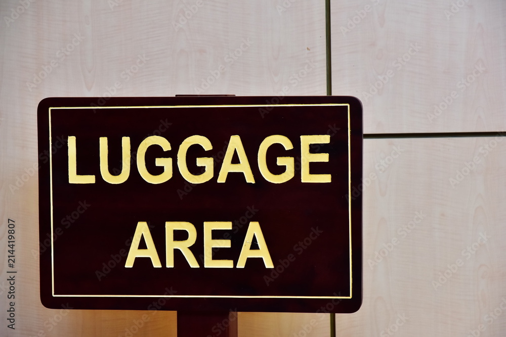 LUGGAGE AREA. The inscription on a wooden dark board. LUGGAGE AREA. The inscription on a wooden dark board.