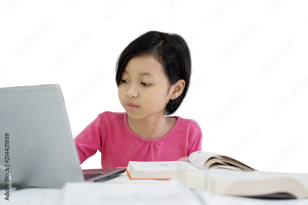Little girl using a laptop on studio Little girl using a laptop on studio