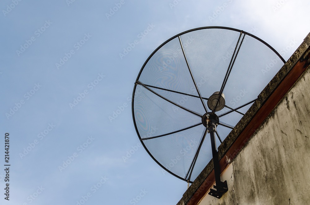 Satellite dish on the roof of old building.
