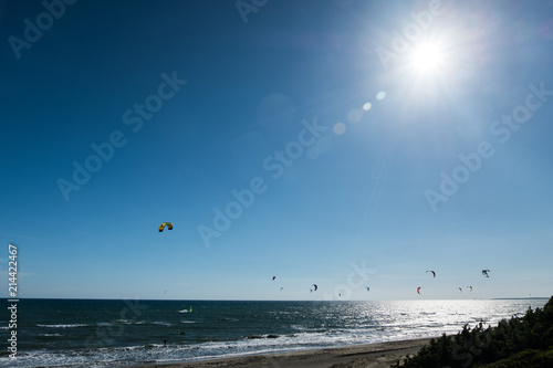 Summer sport background of kitesurf on a bright sunny day. Beautiful outdoor activity wallpaper.