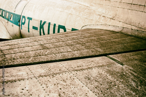 Detail of a vintage abandoned old airplane. Grunge wallpaper background. No people.