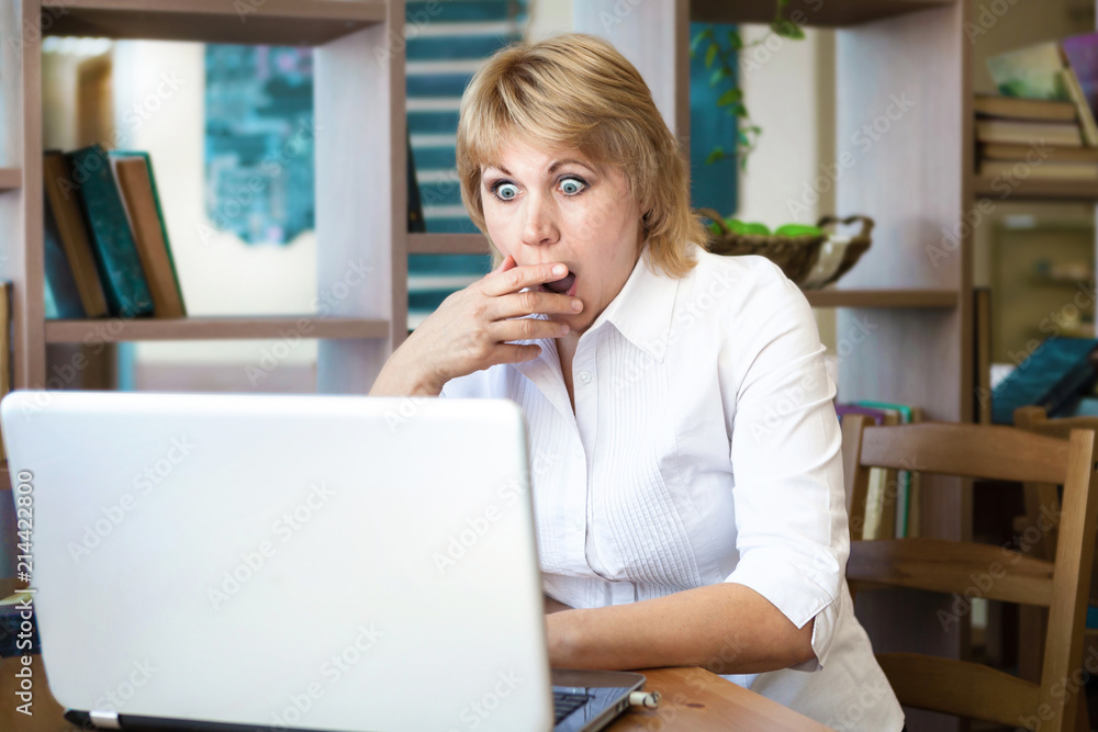 Adult woman looking at laptop Adult woman looking at laptop
