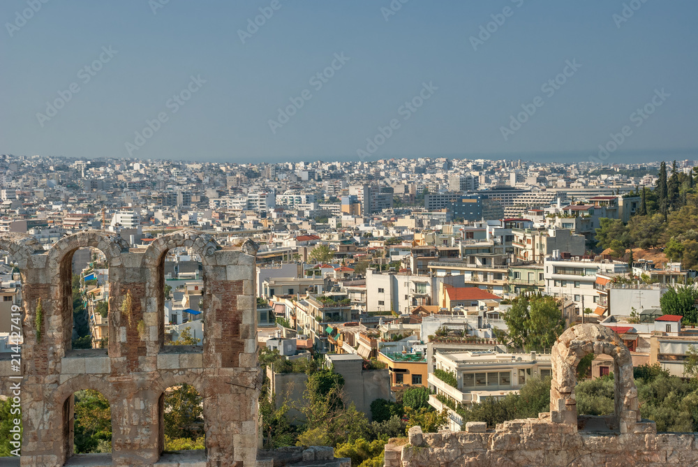 summer view of travel in Greece, tourism is the old ruins of the ancient city on the background of the city of Athens