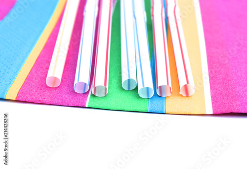Colorful straws on colorful napkin. Plast and paper.