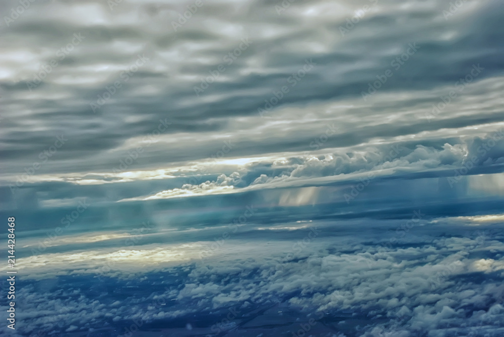 view from the plane above the clouds and the ground