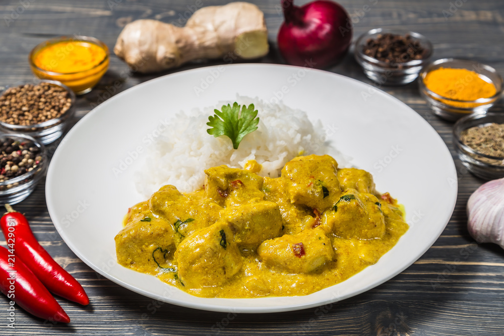 Chicken curry with rice on a dark background. Chicken curry with rice on a dark background.
