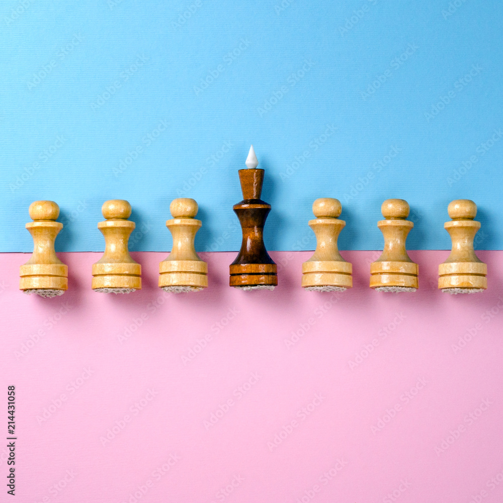 Chess pawns and king. Pink and blue background. Flat lay concept. Pastel shades Chess pawns and king. Pink and blue background. Flat lay concept. Pastel shades