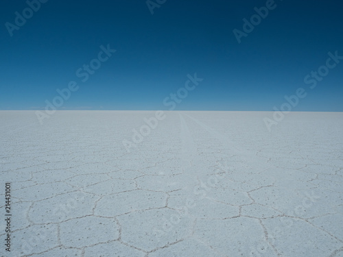 Uyuni Salt flats with bright blue sky and reflections
