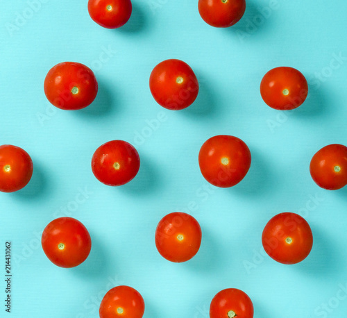 Fresh Cherry Tomatoes on a blue background. Flat lay. Food concept. Pastel shades