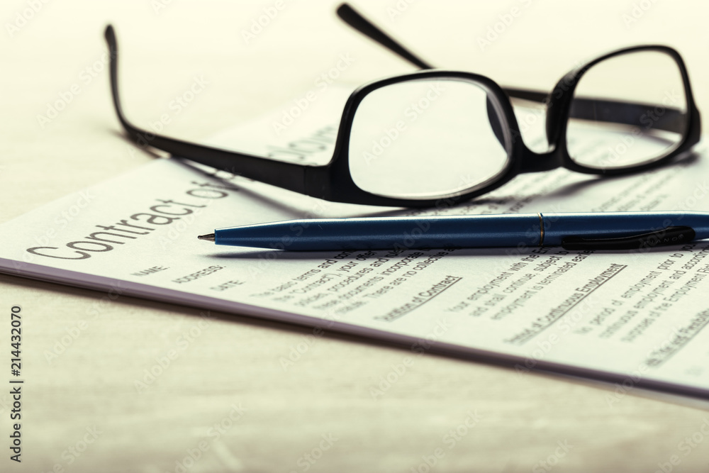 Close up shot of Eyeglasses on contract document papers business concept Close up shot of Eyeglasses on contract document papers business concept